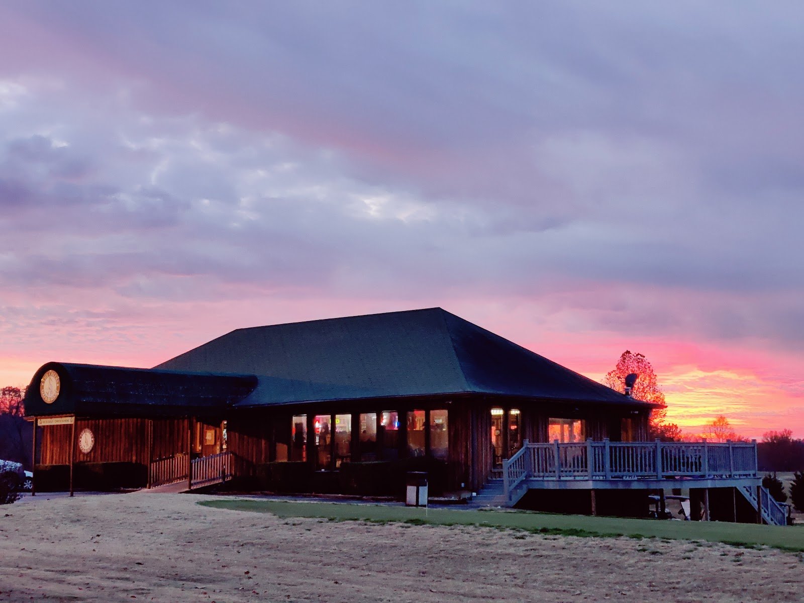 The Creeks clubhouse at dusk with the lights on